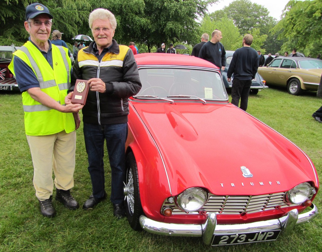 2013 winner as voted by the exhibitors, Colin Payne of Mansfield Woodhouse with his superb 1963 2.2 litre Triumph TR4, being presented with his trophy by 2013 rotary president Jim Haggarty